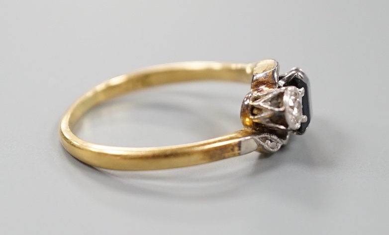 A 1960's 18ct gold, sapphire and diamond set three stone crossover ring, size M, gross weight 3 grams.